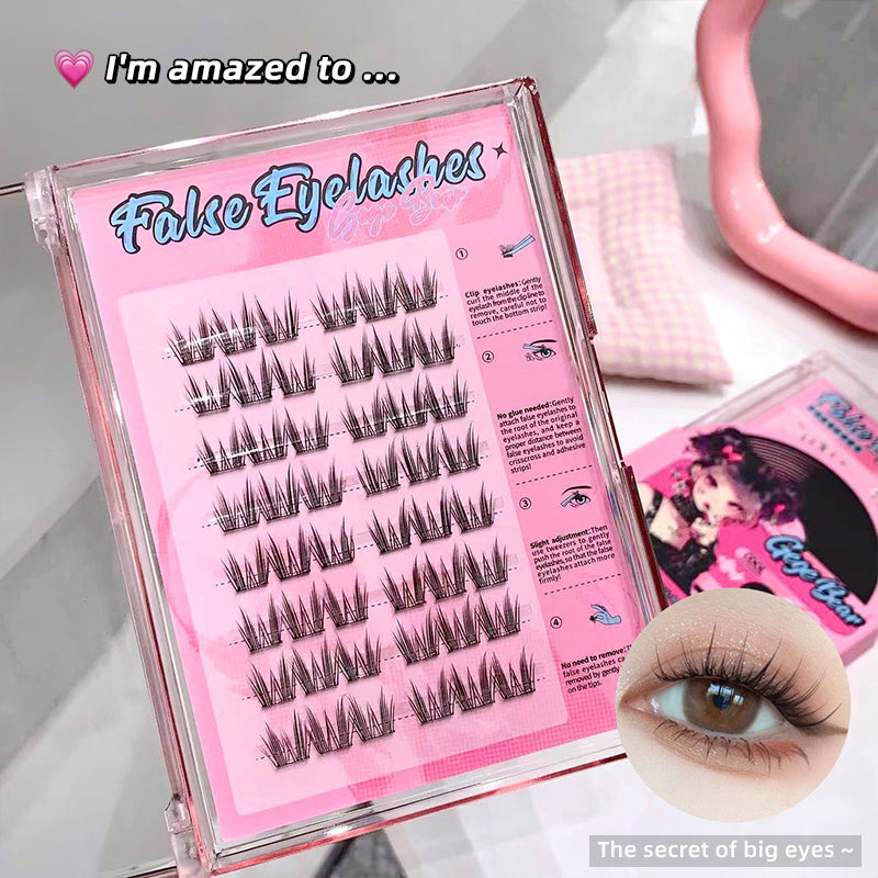 False eyelashes in a pink packaging with an inset of applied lashes.