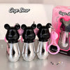 Three metallic bear-shaped lipsticks with a pink box labeled 'Gege Bear' on a reflective surface.