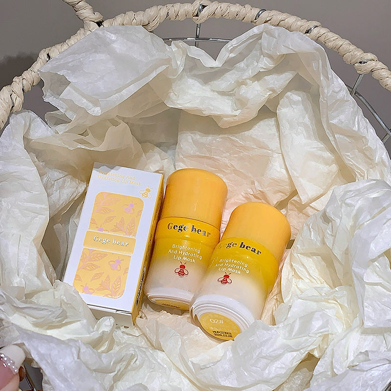 Two yellow bottles and a box with 'Gee Bear' branding on white tissue paper.