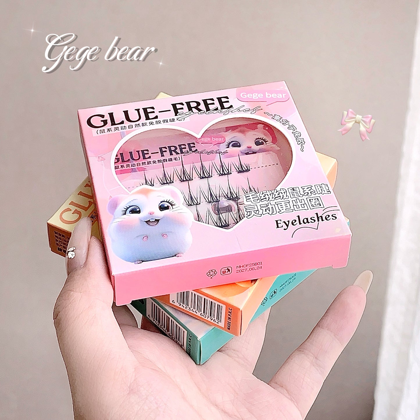 Hand holding a box of glue-free eyelashes with 'gege bear' branding.