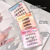 Set of false eyelashes in clear packaging with pink labels on a white surface.