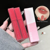 Two pink lip glosses with their packaging held by a hand, on a black background.