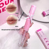 Pink lip gloss with mirror and matte finish on a white surface