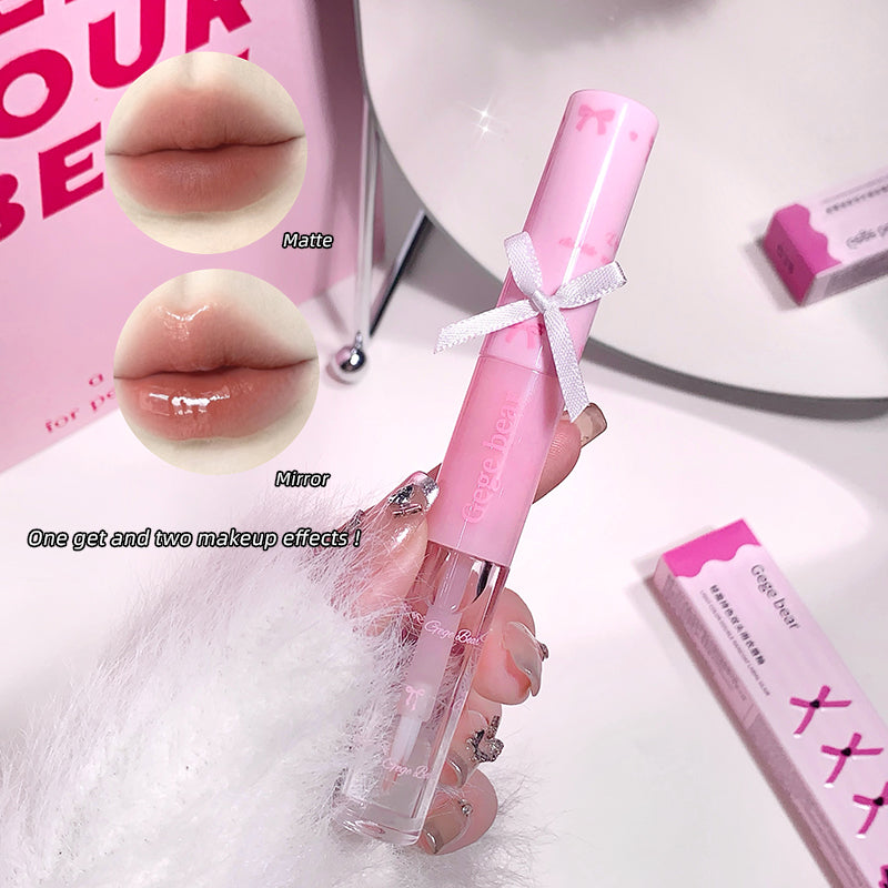 Pink lip gloss with mirror and matte finish on a white surface