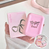 Pink blush powder compact with packaging held by a hand, on a light background.