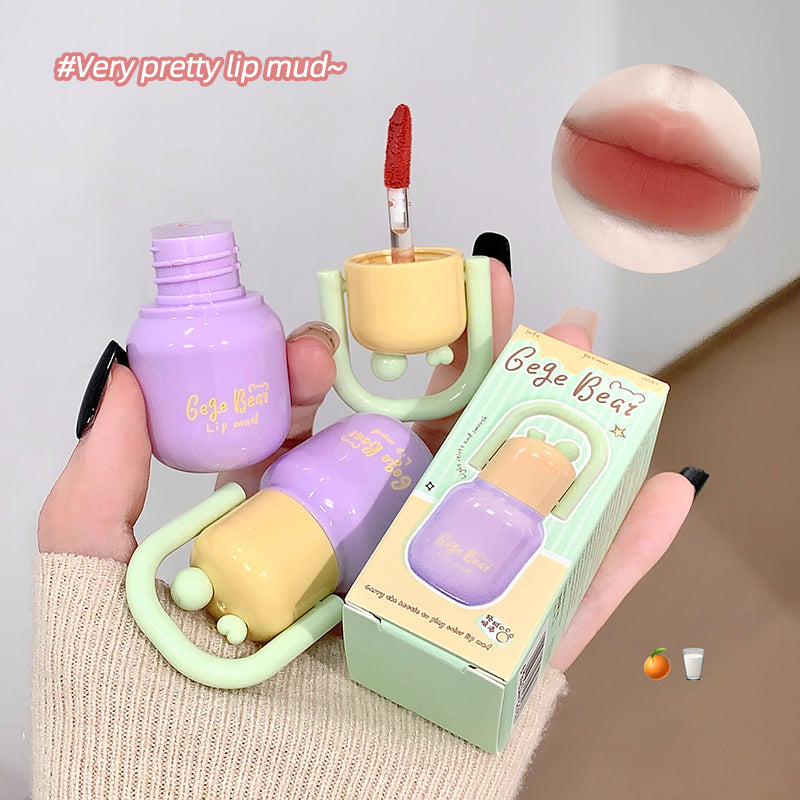 Lip mud product with packaging and close-up of color swatch on a neutral background