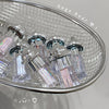 Close-up of a chandelier with crystal-like bottles on a tiled wall background