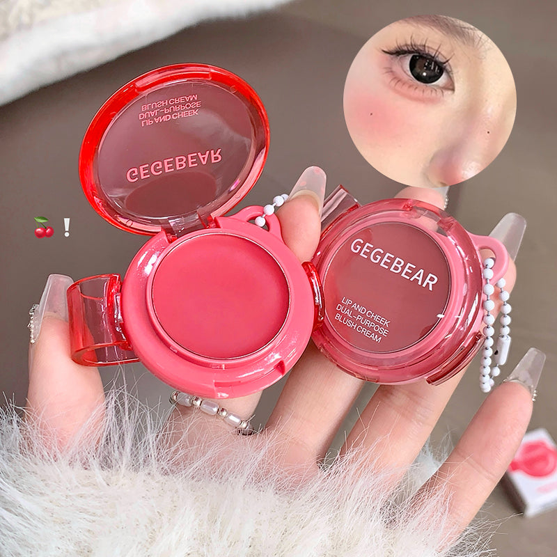 Two pink makeup products with 'GEGEBEAR' branding held by a hand against a neutral background.