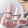 Pink lip gloss with heart design held by a hand, Gege Bear branding visible.