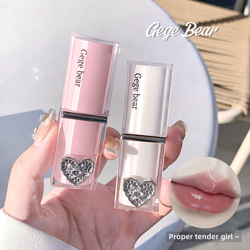 Pink lip gloss with heart design held by a hand, Gege Bear branding visible.