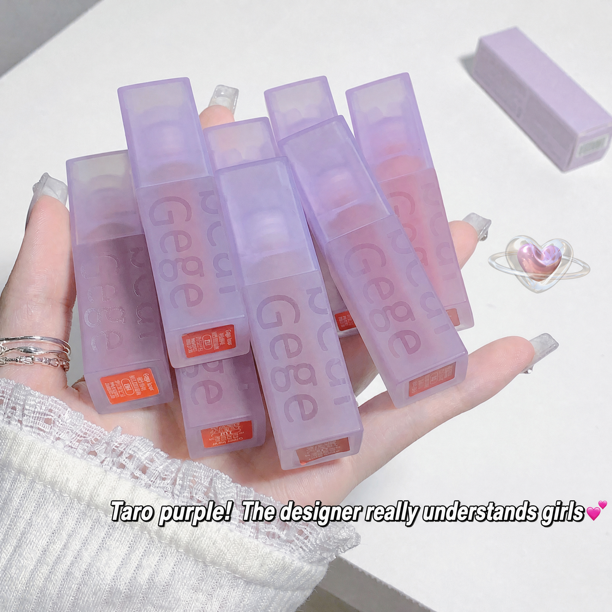 Hand holding multiple purple 'Geepe' products with a white background