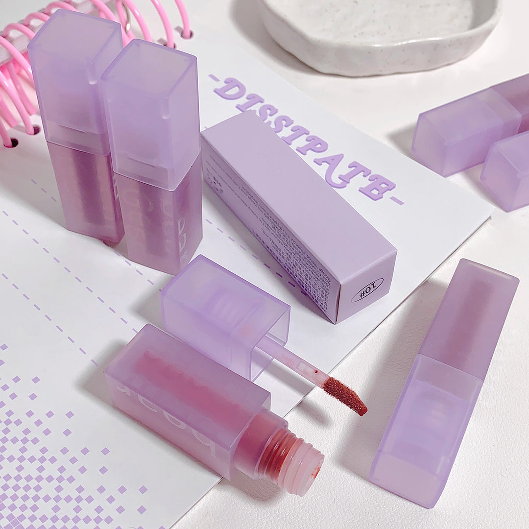 Lip gloss with purple packaging on a white background