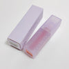 Lavender lip balm with packaging on a light gray background