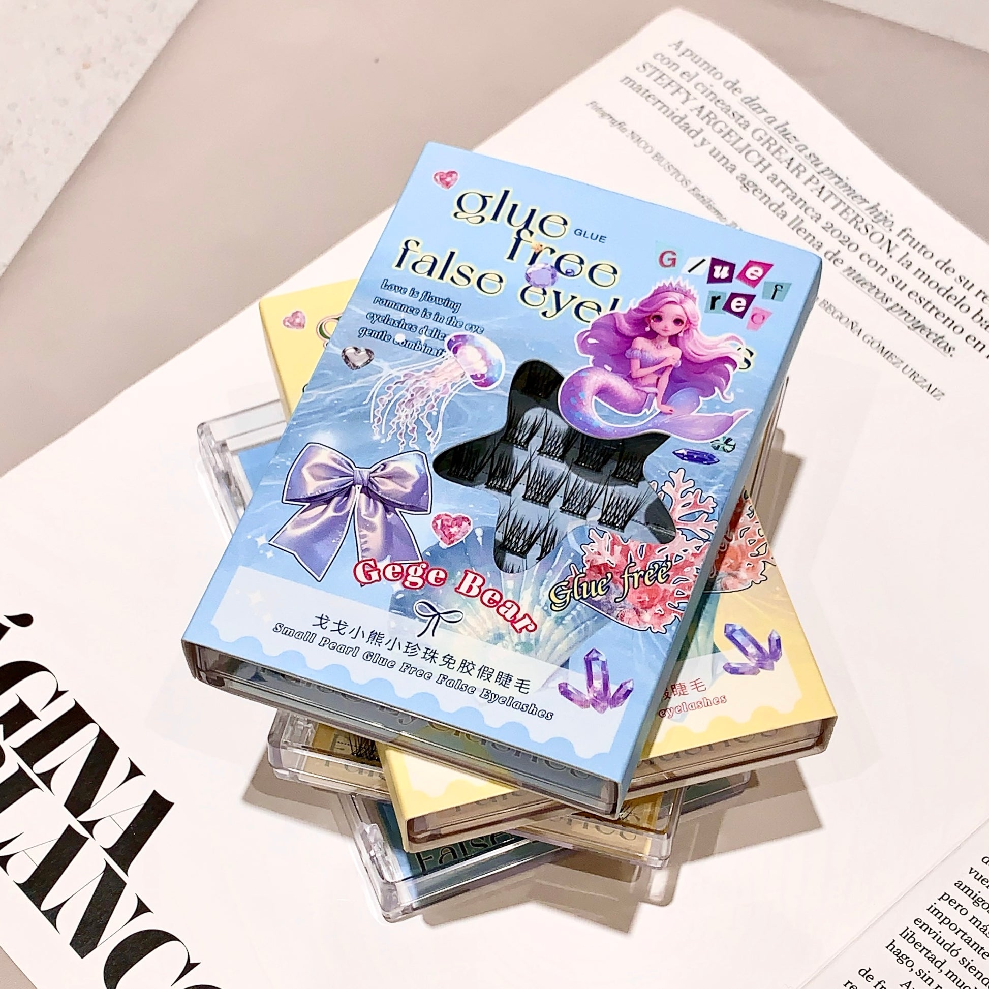 False eyelashes packaging with mermaid design on a magazine