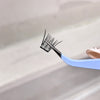 Eyelash extension tool with false eyelashes on a white background
