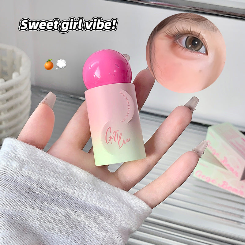 Hand holding a pink and white cosmetic product with a close-up of an eye and text 'Sweet girl vibe!' in the background.