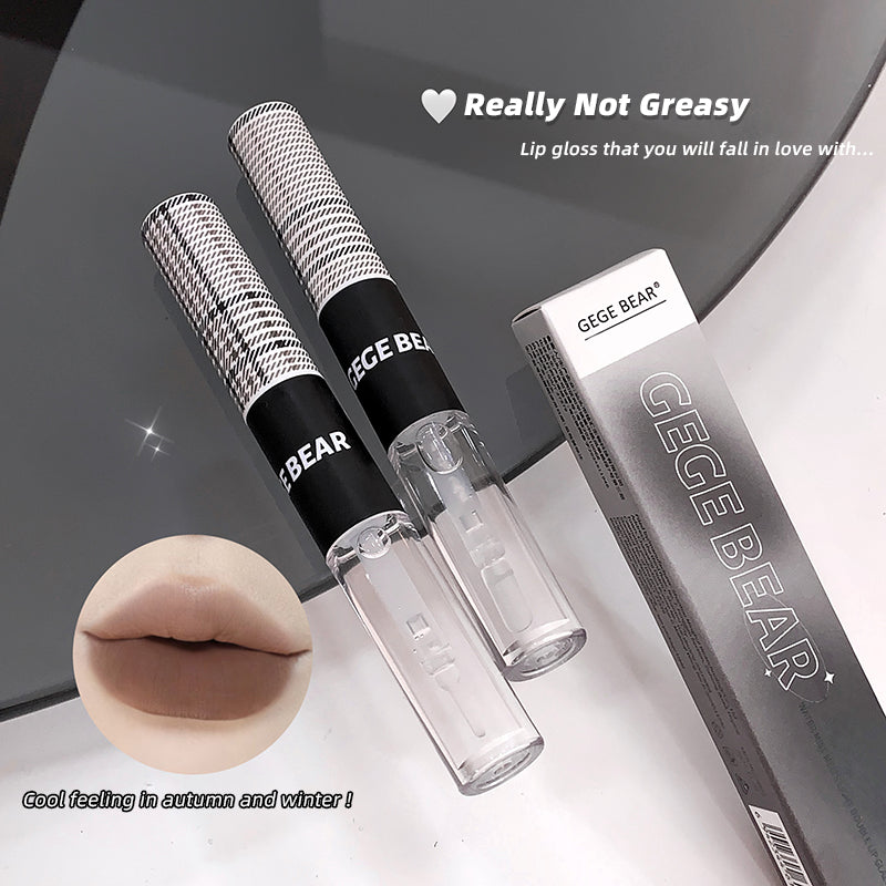 Lip gloss with packaging labeled 'GEGE BEAR' on a reflective surface.