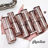 Hand holding multiple L'Oreal lipsticks with a white background