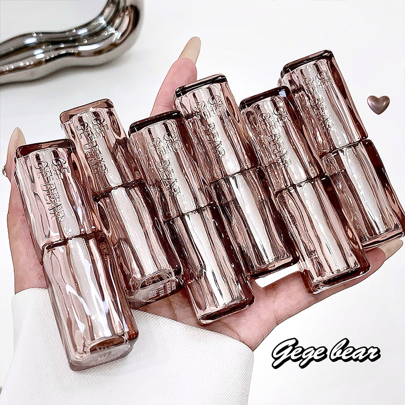 Hand holding multiple L'Oreal lipsticks with a white background