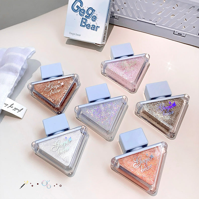 Set of glittery triangular containers with 'Gege Bear' branding on a light surface.