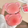 Pink lip balm with bear design held by a hand, with text 'Such a cute blush!'