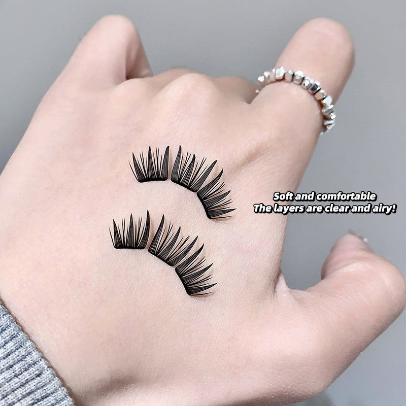 False eyelashes on a hand with a gray background