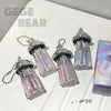 Four transparent containers with colorful contents and silver lids on a white surface, with 'GEGE BEAR' branding.