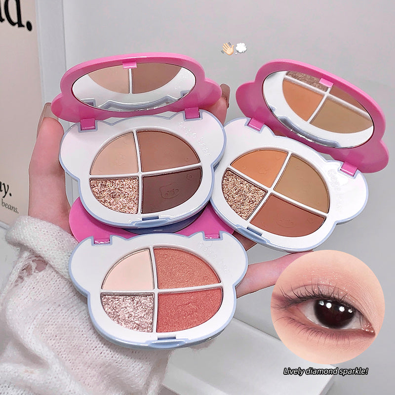 Makeup palette with eyeshadow shades held by a hand, with an inset of an eye wearing the makeup.