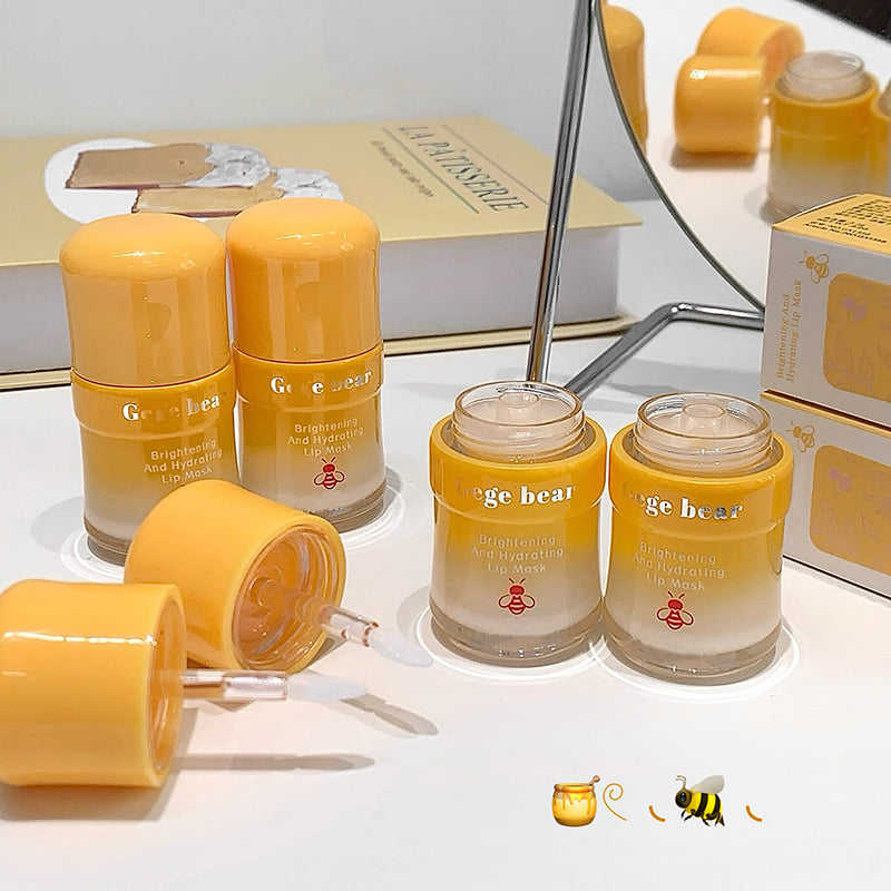 Yellow skincare products with bee design on a white surface