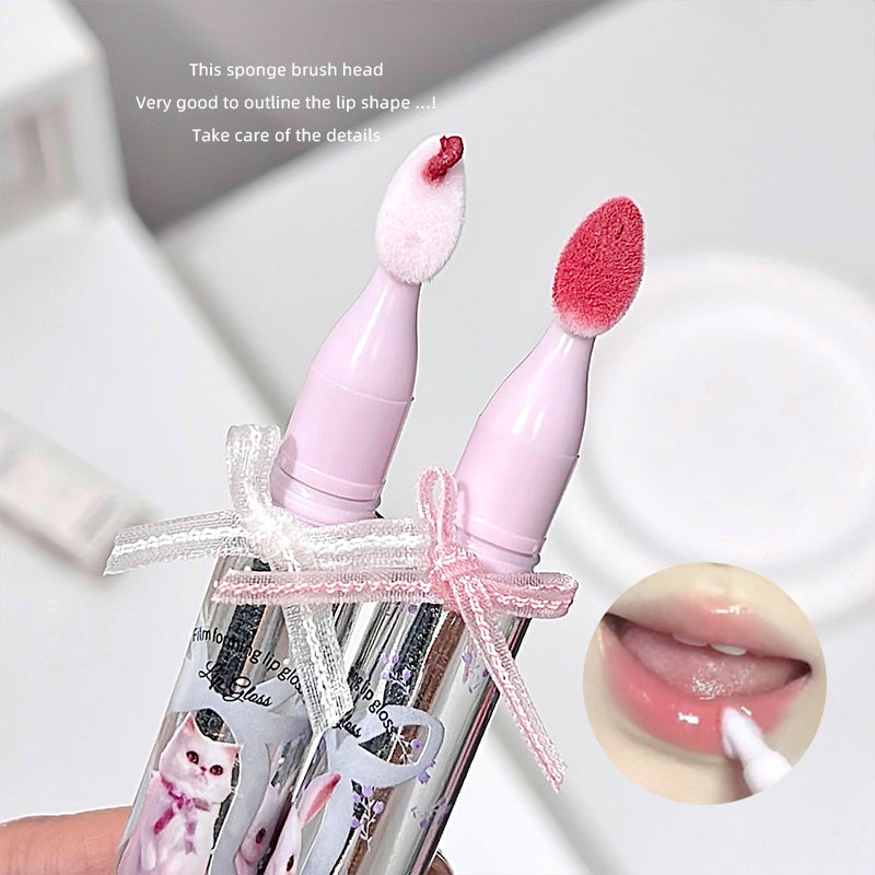Two pink lip brushes with sponge heads in a clear case on a white background.