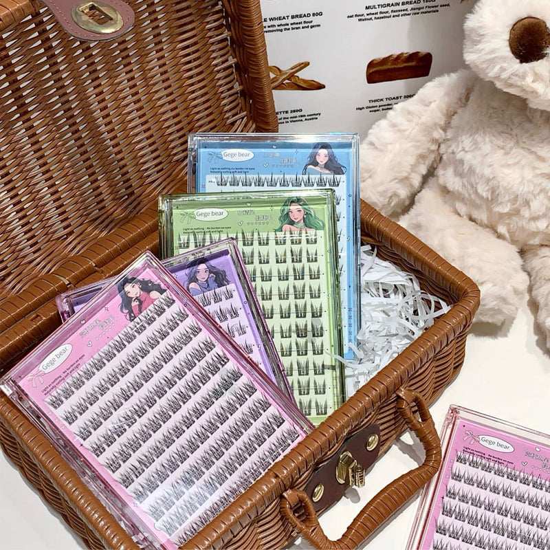 Eyelash packages in a wicker basket with a plush toy in the background