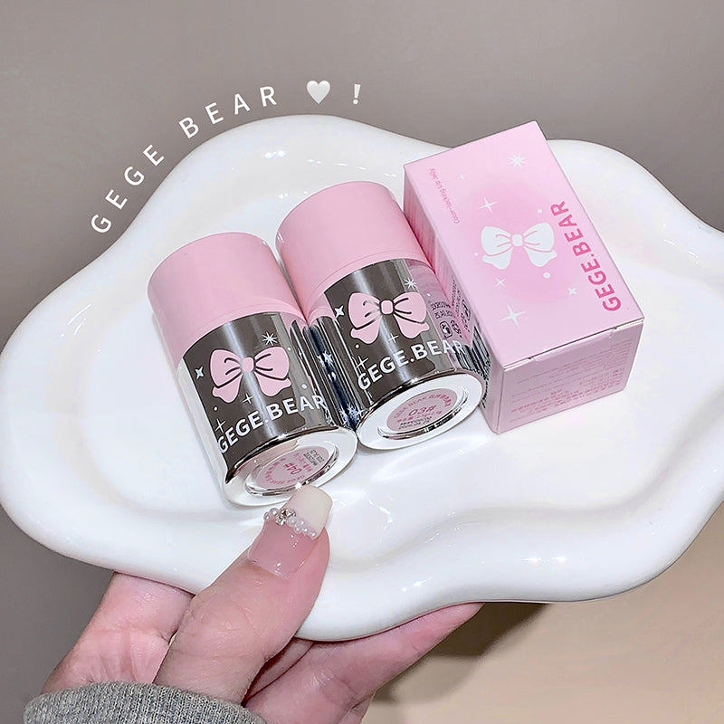 Two pink and gray containers with a pink box labeled 'GEGE BEAR' on a white dish.