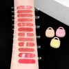 Lipstick swatches on a hand with color codes and small pastel lock-shaped containers.
