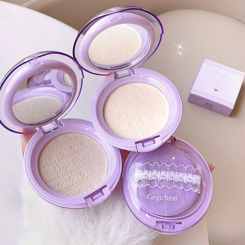 Purple compact powder cases with visible brand name on a light background