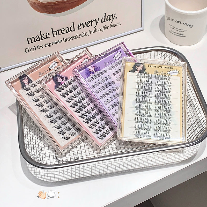 False eyelashes in packaging on a metal tray with a blurred background