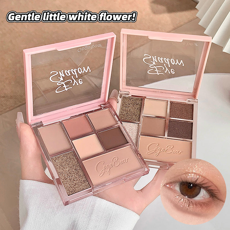 Makeup palette with 'CageBear' branding, held by a hand, with a close-up of an eye wearing the product.