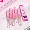 Set of pink lip glosses with a box on a white background