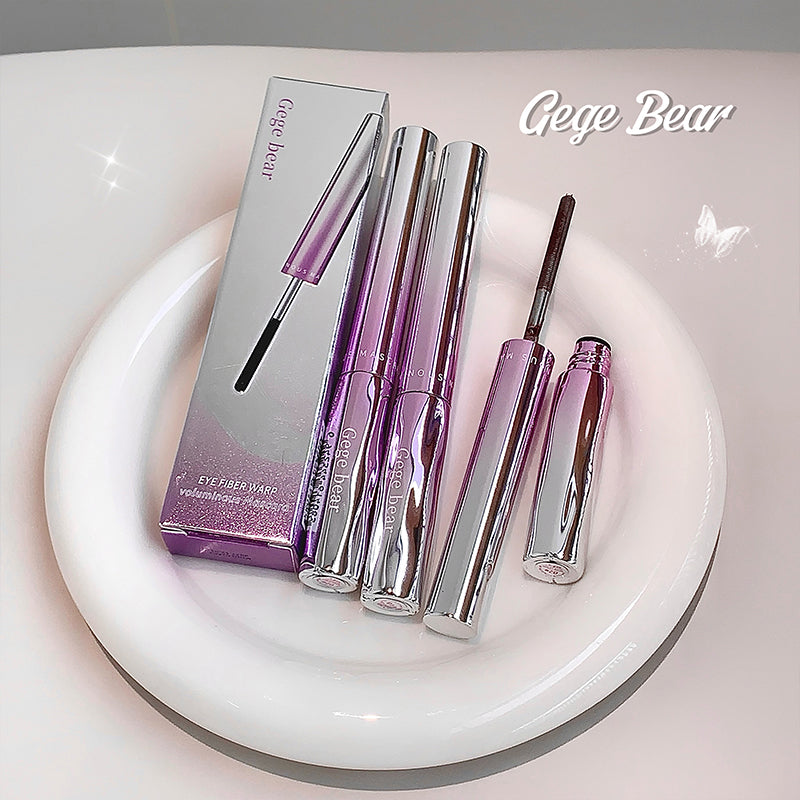 Set of purple and silver eye makeup products with packaging on a white surface, featuring the brand 'Gege Bear'.