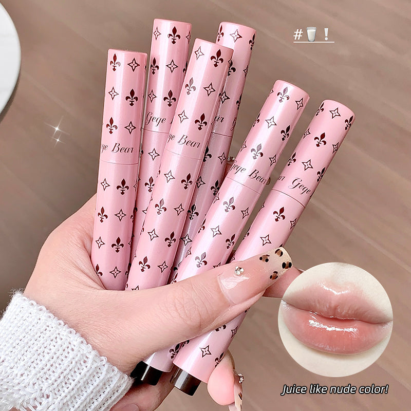 Hand holding six pink lip glosses with decorative patterns on a neutral background