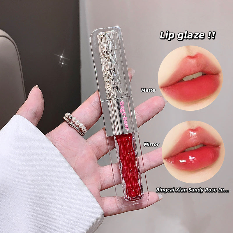 Lip gloss with packaging held in hand, showing matte and mirror finishes on lips.
