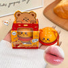 Cute bear-shaped product with packaging held by a person, with a blurred background.