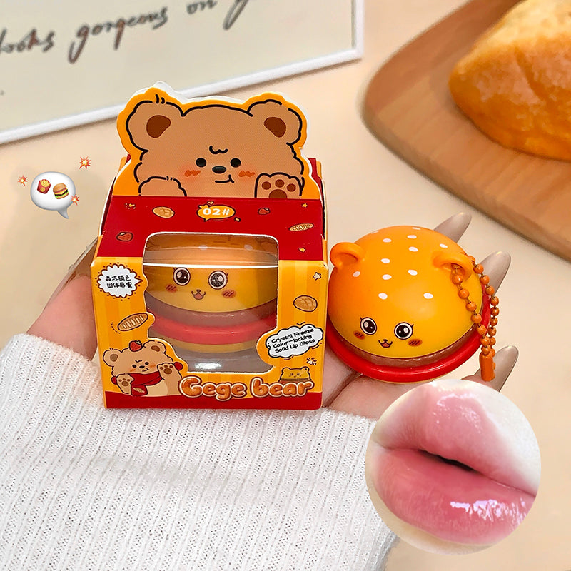 Cute bear-shaped product with packaging held by a person, with a blurred background.