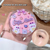 Pink compact foundation case with 'Gege Bear' branding held by a hand, on a wooden surface.