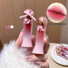 Two pink lip glosses held in a hand with a close-up of lips and text on a beige background.