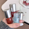 Hand holding three bottles of Gege bear nail polish with a sink in the background