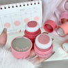Pink makeup sponges with 'Gege bear' branding held by a hand, with a blurred calendar in the background.