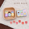 Colorful baby teether set with packaging on a textured surface, featuring the brand 'GEGE BEAR'.