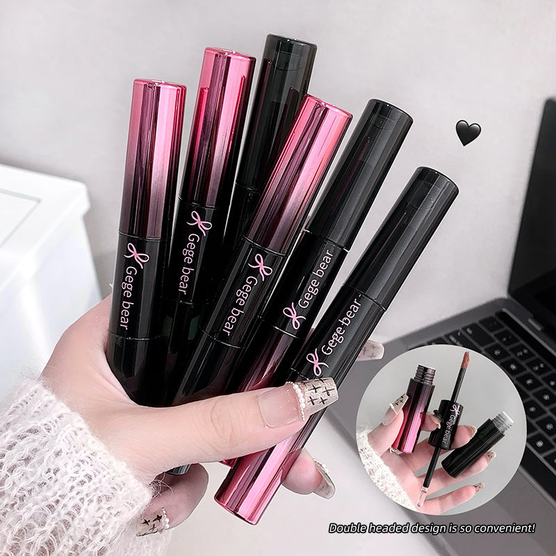 Hand holding multiple Geee bear lip glosses with a laptop in the background