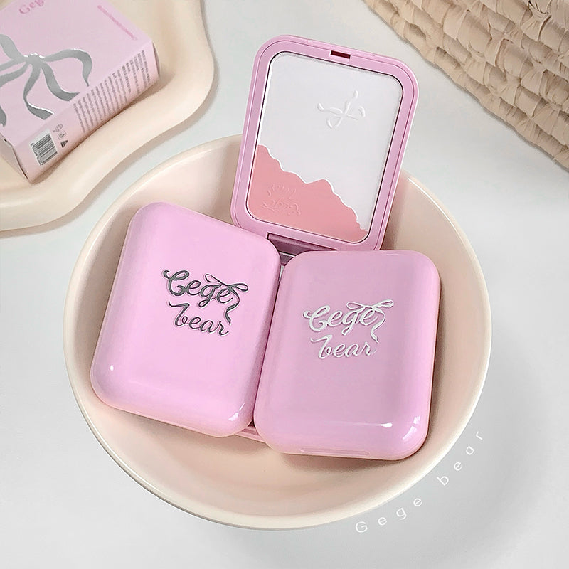 Pink makeup compact with 'Gege bear' branding on a white plate.