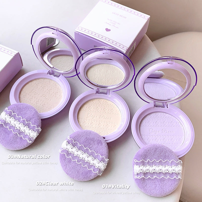 Purple makeup compact with lace details on a light background